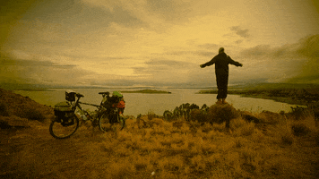 travismccrea bike cinemagraph lake man on rock GIF