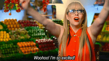 Reality TV gif. A woman on Masterchef raises both of her arms, smiles, and looks up, saying, "Woohoo! I'm so excited!"