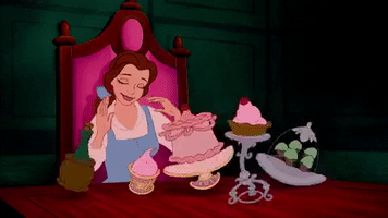 Movie gif. Belle in the cartoon Beauty and the Beast sways in a dance as plates of food dance happily on the table in front of her. 