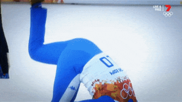 Sports gif. A Winter Olympics athlete does a somersault on the winners stand onto snowy ground.