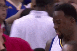 Sports gif. During an NBA game, a frustrated Draymond Green of The Golden State Warriors walks off the court, shaking his head in disagreement.