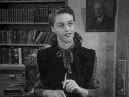 Movie gif. Dorothy Malone in The Big Sleep. She is a bookseller in a bookshop and looks taken aback but interested as she says, "Well," and walks off to find the item requested.