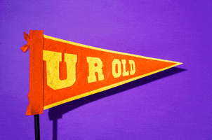 Stop motion gif. A pennant flag blows in the wind over a plain background. Text on the flag says, "U R Old."
