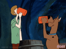 Cartoon gif. Scooby and Shaggy are holding matching orange cups and are chugging the contents at full speed. Their necks move at the same time, speedily and unrelenting.