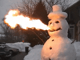 Video gif. Snowman wearing a top hat blows fire out of his mouth.