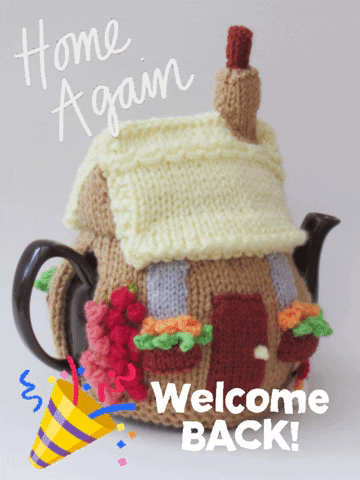 Photo gif. Black tea pot that has a cottage tea cozy knitted around it. In the corner is a sticker of a horn that blows confetti out. Text, “Home again. Welcome back!”