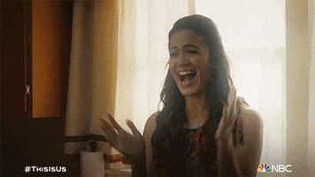 TV gif. Mandy Moore as Rebecca in This Is Us laughs and claps with joy.