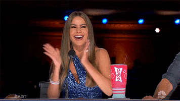 Reality TV gif. Sofia Vergara on America’s Got Talent claps her hands excitedly with a big smile.