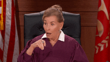 TV gif. In disbelief, a stunned Judge Judy shakes her head.