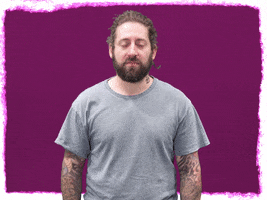 Celebrity gif. Joe Trohman from Fall Out Boy gives us a passionate, you-can-do-it look as he raises crossed fingers to eye level, wishing for the best. 