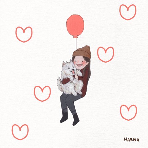 happy person cuddling a puppy while being carried by a balloon