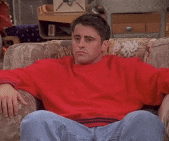 Friends gif. Matt LeBlanc is sunk into a cozy chair when his eyes grow wide; he looks to the left and to the right with shock.