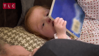 baby reading book gif