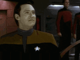 TV gif. Brent Spiner as Data in Star Trek: The Next Generation, pumps his fist downward exclaiming "yes!" under his breath, and pumps again in excitement. 