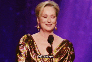 Celebrity gif. Meryl Streep stands at the microphone in a gold dress at the Oscars as she gives a speech. She shakes her head, smiling, throwing up a hand as she says, "Whatever."