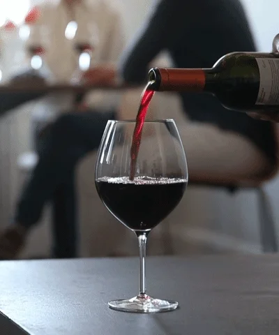 Wine pouring inside of glass
