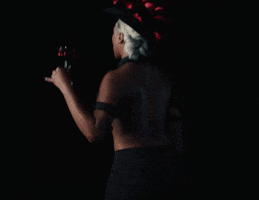 Celebrity gif. Megan Thee Stallion tosses a pair of handcuffs to the side as she struts away from us and all we see is the back of her head and her back.