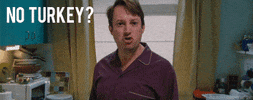 TV gif. David Mitchell as Mark in Peep Show. He's standing in the kitchen and looks livid as he says through gritted teeth, "No turkey?!"
