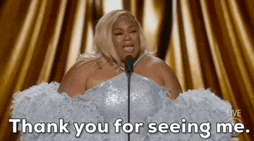 Oscars 2024 gif. Da'Vine Joy Randolph resolutely pumps her arm down and says tearfully, "Thank you for seeing me."