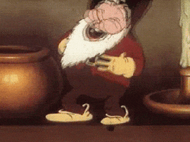 Cartoon gif. A dwarf or very small man with a white beard stands on a ledge next to a candlestick taller than him. He rocks back and forth slowly holding his belly as he laughs. 