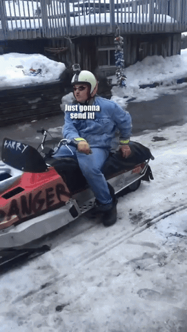 Video gif. A man on a snowmobile is sitting with a helmet that has a GoPro on it and sunglasses. He looks calm but eager as his mouth stays open and he says, "Just gonna send it!"