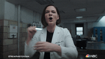 TV gif. Sandra Mae Frank as Dr. Wilder in New Amsterdam pumps her fist into the air in celebration and yells, “yes!”