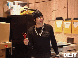 Reality TV gif. Criss Angel from Mindfreak holds a pair of scissors and looks at someone in amusement before asking, "Are you drunk again?"