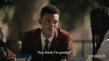 TV gif. Jabari Banks as Will on The Fresh Prince of Bel-Air sits at a table with a flirtatious expression on his face as he looks over at Simone Joy Jones as Lisa Wilkes next to him. He says, “You think I’m pretty?”