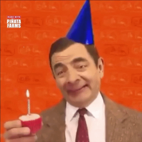 Video gif. Rowan Atkinson as Mr. Bean wearing a bright blue birthday hat askew on his head holds a cupcake with a lit candle. He blows out the candle while making wide exaggerated eyes then nods and smiles at us with a silly and delighted expression. 