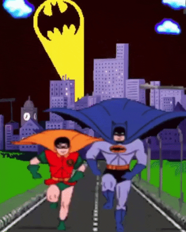 Digital art gif. Batman and Robin run towards us on a road, away from a city, while the bat signal appears in the sky.