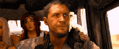 Movie gif. Tom Hardy as Max in Mad Max sits in the driver's seat of a car with several others. He shakes his head and points out the windshield. "That's bait," he says, which appears as text.