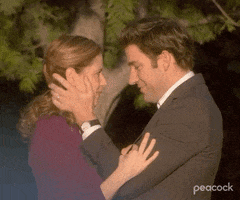 The Office gif. John Krasinski as Jim holds the face of Jenna Fischer as Pam as he says, "I love you," then kisses and embraces her.