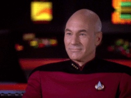 Star Trek gif. Patrick Stewart as Jean-Luc Picard and James Doohan as Scotty proudly raise a toast and drink a bright lime green liquid.