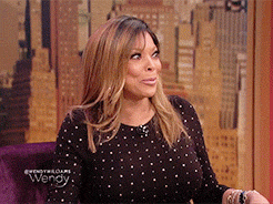 Reality TV gif. Wendy Williams is on the Wendy Williams show and she looks very amused as she looks around at the audience with wide eyes and a closed lipped smile. She picks up her teacup and takes a big sip while staring directly at us.