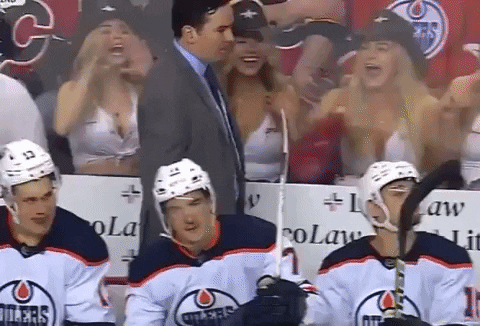 Edmonton Oilers coach Jay Woodcroft stands behind the bench during