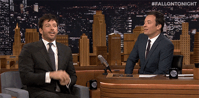 TV gif. Jimmy Fallon and his guest lift up their hands to their mouths and say, “BOOOOOOOOO!”