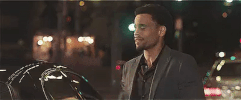 Movie gif. Michael Ealy as Dominic in Think Like a Man kisses his clenched fists as he looks upward and then pumps them toward the sky. 