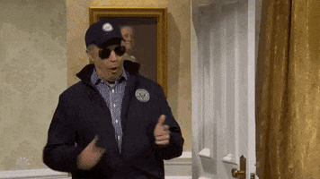 SNL gif. Jason Sudeikis as Joe Biden stands in the doorway of the White House, wearing dark sunglasses and a hat. He twists his back, pretending to shoot behind his back with his fingers.