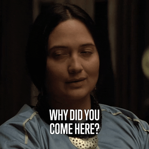 TV gif. Lily Gladstone as Mollie in "Killers of the Flower Moon" looks to one side and slowly blinks her eyes giving an annoyed or bored expression as she says, "Why did you come here?'