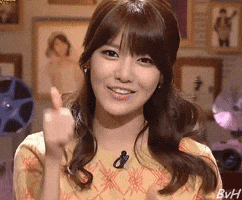Celebrity gif. Choi Soo Young from Girls' Generation, a Korean idol group, kisses each one of her fingers on one hand before giving us a double thumbs up. 