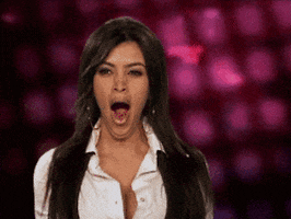 Celebrity gif. Kim Kardashian is giving us a fat yawn and the video is looped on the moment she stretches her mouth to its widest. 