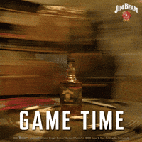 Sponsored gif. Rapidly spinning view of a bottle of Jim Beam Black bourbon whiskey suddenly slows down to show a more detailed shot of the bottle. Text reads, “Game time.”