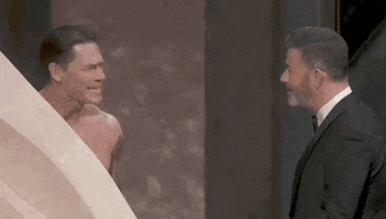 Oscars 2024 GIF. Jimmy Kimmel and John Cena are having an argument on stage as to why Cena doesn't want to come out naked. Kimmel mentions that he has wrestled naked but Cena says, "I wrestled in jorts!" Kimmel retorts with, "Jorts are worse than naked."