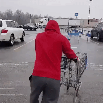 Man Slides Across Icy Parking Lot to Return Shopping Cart