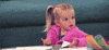 TV gif. Mia Talerico as Charlie on Good Luck Charlie shrugs and and draws her chin back with a surprised expression as she looks around.