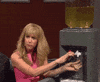 SNL gif. Kirsten Wiig is pouring herself a glass of wine from a huge water dispenser that has wine in it. She mocks someone by opening and closing her mouth noisily.