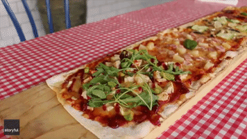 Model Devours Meter-Long Pizza in Under Five Minutes