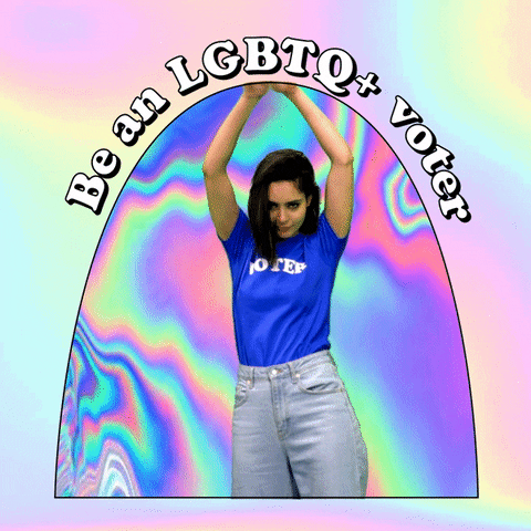 Video gif. Woman wearing a blue “Voter” t-shirt dances enthusiastically as she waives a gay pride flag and a transgender pride flag. Retro tie dye colors wiggle in the background. Text, “Be an LGBTQ+ voter.”