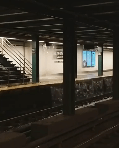 Straphangers Dodge Waterfall at Brooklyn Subway Station During Floods