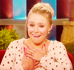 Celebrity gif. Actor Kristen Bell on Ellen reacts to something with awe. One hand goes to her chest and the other to her mouth as she reacts to something cute or heartfelt. 